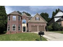 Charming brick home with a well-manicured lawn and two-car garage in a desirable neighborhood at 4990 Arbor View Nw Pkwy, Acworth, GA 30101