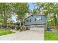 Charming two-story home with blue siding, brick accents, and a two-car garage at 1348 Branchwood Dr, Snellville, GA 30078