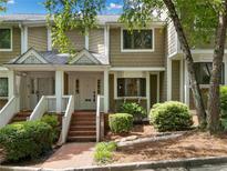 Inviting townhome exterior featuring a well-maintained facade, brick steps and mature landscaping at 6 Alston Place Ne Ne Pl, Atlanta, GA 30324