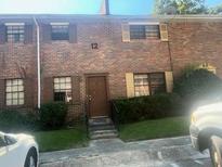 Charming brick townhome with well-maintained landscaping and inviting entrance at 6354 Shannon Pkwy # 12D, Union City, GA 30291