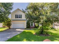 Charming two-story home features a well-manicured lawn, attached garage, and inviting front entrance at 1273 Royal Ives Ct, Lawrenceville, GA 30045