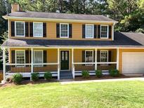 Charming two-story home with a welcoming front porch and a well-manicured lawn at 2751 Herron Cir, Snellville, GA 30039