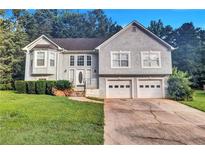 Charming two-story traditional home with a well-manicured lawn and a two-car garage at 11739 Sawgrass Ct, Fayetteville, GA 30215