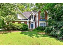 Charming brick home featuring a well-manicured lawn and mature trees in a desirable neighborhood at 2866 Wynford Sw Dr, Marietta, GA 30064