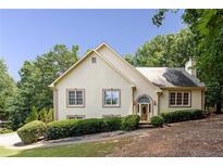 Charming traditional-style home with an arched entryway and manicured landscaping at 629 Pine Ter, Canton, GA 30114