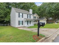 Charming two-story home featuring a classic design, well-maintained lawn, and inviting front porch at 425 Orchard Dr, Stone Mountain, GA 30083