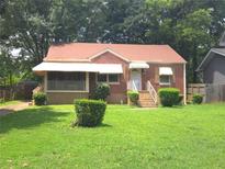 Charming brick home with a well-maintained lawn and covered front porch at 1712 Clifton Se Way, Atlanta, GA 30316