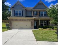 Charming two-story home with a well-manicured lawn and a two-car garage, creating a welcoming curb appeal at 239 Lenore Ct, Hiram, GA 30141