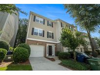 Charming townhome with brick accents, attached garage, manicured landscaping, and inviting front entrance at 734 Celeste Sw Ln # 84, Atlanta, GA 30331