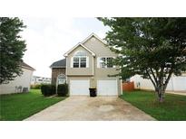 Charming two-story home featuring a two-car garage and well-maintained front yard at 11854 Registry Blvd, Hampton, GA 30228