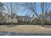 Stunning exterior elevation showcasing its beautiful stonework, elegant roofline and perfectly manicured landscaping at 4340 Garmon Rd Nw, Atlanta, GA 30327
