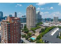 Stunning aerial view of the Oaks Buckhead community with high-rise buildings and a refreshing pool at 3475 Oak Valley Ne Rd # 910, Atlanta, GA 30326