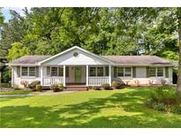 Charming single-story home with a well-manicured lawn and inviting front porch at 3999 Phils Ct, Tucker, GA 30084