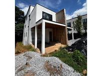 Exterior view of a modern home under construction with a covered porch and large windows at 314 Fortune Ne St # A, Atlanta, GA 30312
