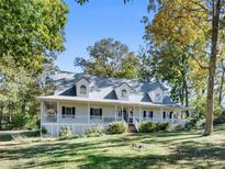 Charming home with a large, inviting wraparound porch and well-manicured front lawn at 3530 Dahlonega Hwy, Cumming, GA 30028