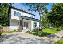 Modern two-story home with a concrete driveway and a well-manicured lawn at 833 Humphries Sw St, Atlanta, GA 30310