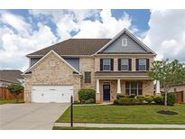 Charming two-story brick home featuring a two-car garage and beautifully landscaped front yard at 1261 Palouse Hills Pl, Lawrenceville, GA 30044