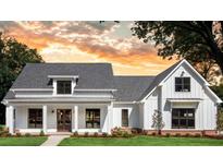 Charming modern farmhouse featuring a white exterior, gray roof, and meticulously maintained landscaping at 1290 Jack Page Ln, Canton, GA 30115