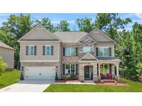 Charming two-story home with a brick and stone facade and well-manicured lawn at 625 St Annes Pl, Covington, GA 30016