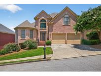 Charming brick two-story home with manicured landscaping, two-car garage, and inviting curb appeal at 2002 Ivy Ridge Se Rd, Smyrna, GA 30080