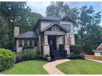 Charming two-story home features a landscaped front yard with craftsman architecture and an inviting front porch at 2088 Emery Ne Pl, Atlanta, GA 30317