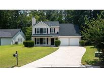 Charming two-story home featuring a well-manicured lawn and a two-car garage at 2161 Denson Sw Ln, Marietta, GA 30008