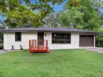 Charming single-story home with a manicured lawn, painted brick, and a cozy front porch at 5207 White Sw Blvd, Mableton, GA 30126