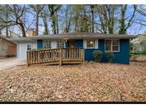Charming blue brick home with a wooden wheelchair ramp leading to the front door at 1089 Indale Sw Pl, Atlanta, GA 30310