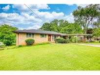 Charming single-story home with a lush green lawn and a convenient carport at 1342 Peggy Nw Ln, Conyers, GA 30012