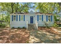 Charming single-story home featuring blue shutters and a well-maintained front yard at 1324 Almont Sw Dr, Atlanta, GA 30310