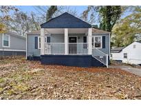 Charming blue home with a covered front porch and freshly painted blue trim at 1417 Graymont Sw Dr, Atlanta, GA 30310