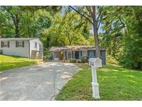 Charming single-story home featuring a well-maintained lawn, long driveway, and classic mailbox at 3530 Fairlane Nw Dr, Atlanta, GA 30331