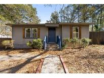 Charming single-story home with gray siding, blue door, and well-maintained landscaping at 501 Aberdeen Nw Dr, Atlanta, GA 30318