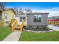 Charming home featuring new wood deck, landscaped flower bed, and a well maintained green lawn at 1 Lamar Ave Sw, Atlanta, GA 30310