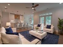 Bright, open-concept living area with modern finishes, connecting seamlessly to the kitchen and dining space at 3007 Holly St, Canton, GA 30115