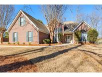 Charming brick home featuring manicured landscaping and inviting entrance at 1585 Lake Dow Rd, Mcdonough, GA 30252