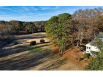 Scenic golf course view backing up to a well-maintained home in a lush, wooded area at 138 Elysian Nw Way, Atlanta, GA 30327