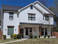 Inviting two-story home with modern farmhouse design, featuring a white facade and dark window trim at 2173 Montrose Sw Ave, Atlanta, GA 30311