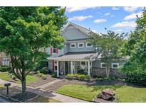 Charming two-story home featuring stone accents, manicured landscaping, and a welcoming front porch at 207 Harmony Lake Dr, Canton, GA 30115