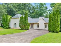 Charming single-story home with manicured lawn and elegant driveway at 4260 Keheley Lake Ne Dr, Marietta, GA 30066