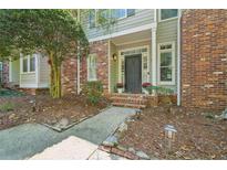 Charming brick and siding home with a well-maintained front yard and welcoming entrance at 171 Riverview Trl, Roswell, GA 30075