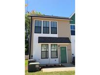 Charming two-story home with black-trimmed windows and a green front door at 1095 Tucker Ave # 208, Atlanta, GA 30310