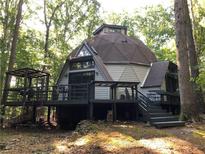 Unique dome home with a spacious deck, surrounded by lush trees, offering a private and serene outdoor living experience at 5015 Wright Bridge Rd, Cumming, GA 30028