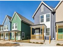 Colorful new construction townhomes with individual front porches and modern design elements, set against a clear blue sky at 1095 Tucker Ave # 401, Atlanta, GA 30310
