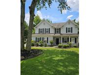 Charming two-story home with manicured lawn, black shutters, and inviting front porch at 4845 Weathervane Dr, Alpharetta, GA 30022