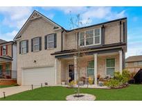 Charming two-story brick home with attached garage and a well-manicured front yard at 7246 Gladstone Cir, Lithonia, GA 30038