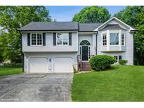 Charming home with a two-car garage and beautifully landscaped front yard at 75 Willow Bend Nw Dr, Cartersville, GA 30121