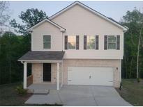 Charming two-story home with a brick facade, attached two-car garage, and covered front porch at 558 Fairview Oak Pl, Dallas, GA 30157