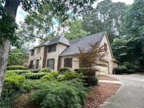 Charming brick home with mature landscaping and a side-entry garage at 4116 River Cliff Chase Se, Marietta, GA 30067