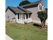 Charming home showcasing its architectural details, tidy yard, and welcoming front porch at 2315 Oakland Spring Dr, Snellville, GA 30039